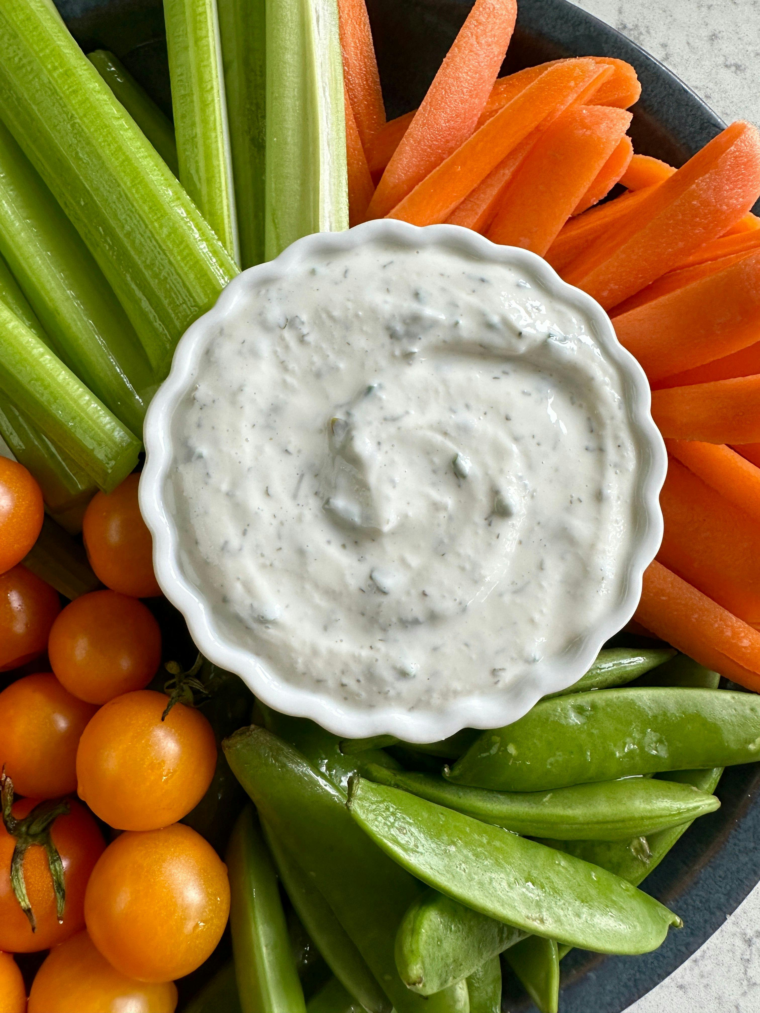 Cottage Cheese Ranch Dip in a small bowl surrounded by a variety of vegetables. 