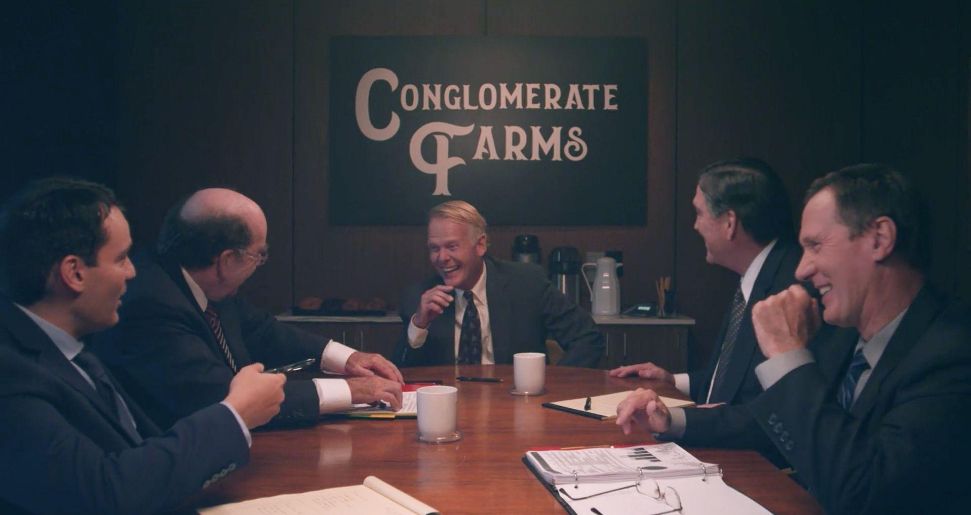 Men in suits around a boardroom table.