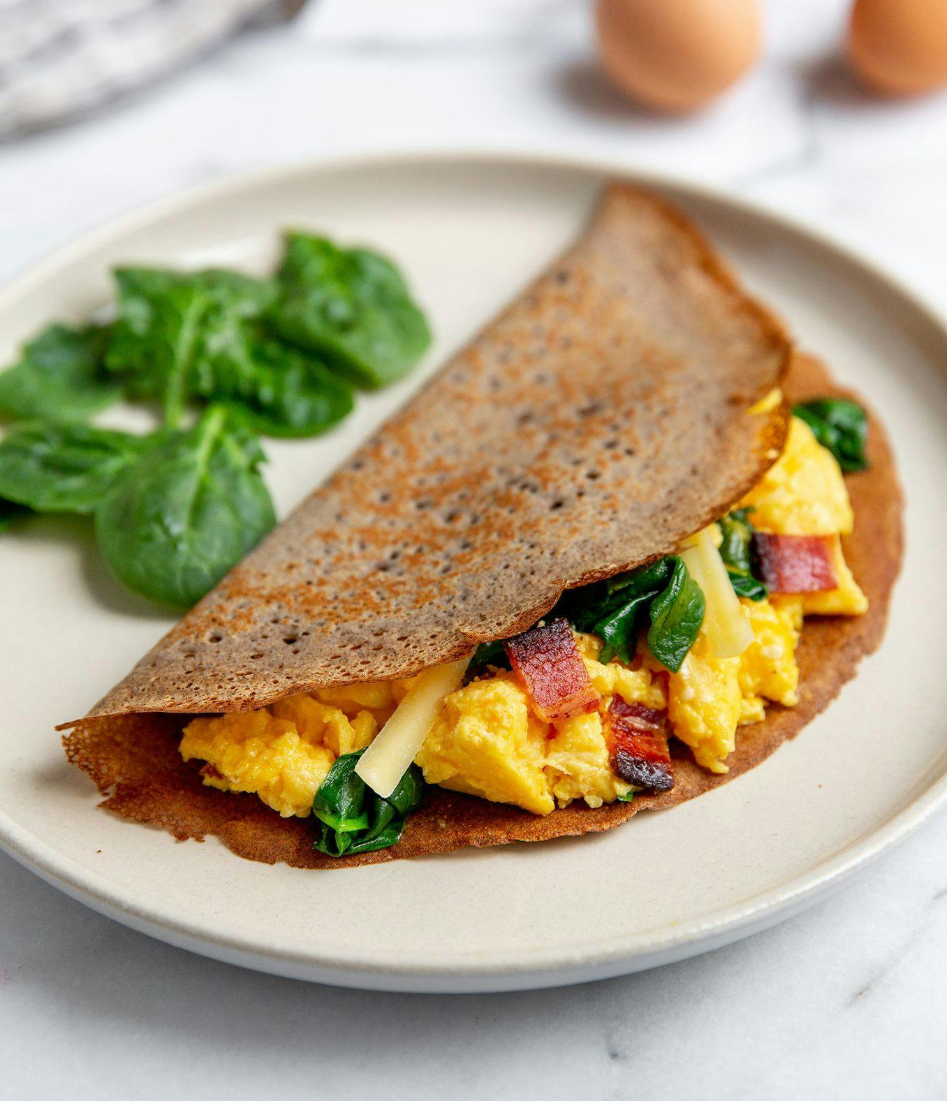Gluten-Free Crepe with a side of spinach. 