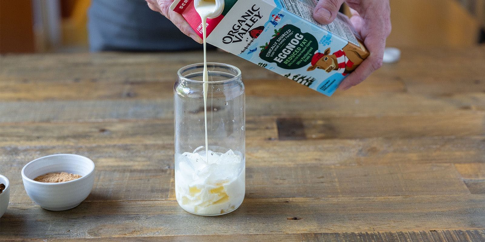 Pouring Organic Valley Eggnog in a glass.