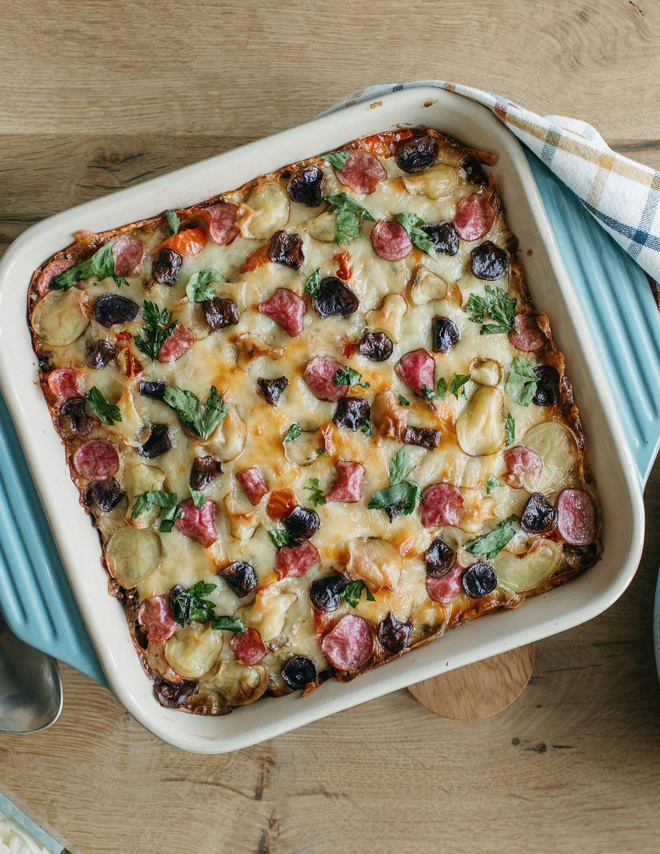 Easy Cheesy Garden hotdish with a variety of vegetables in a square pan. 