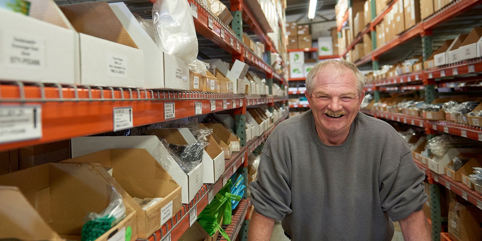 Organic Valley warehouse employee picks products along the aisles.