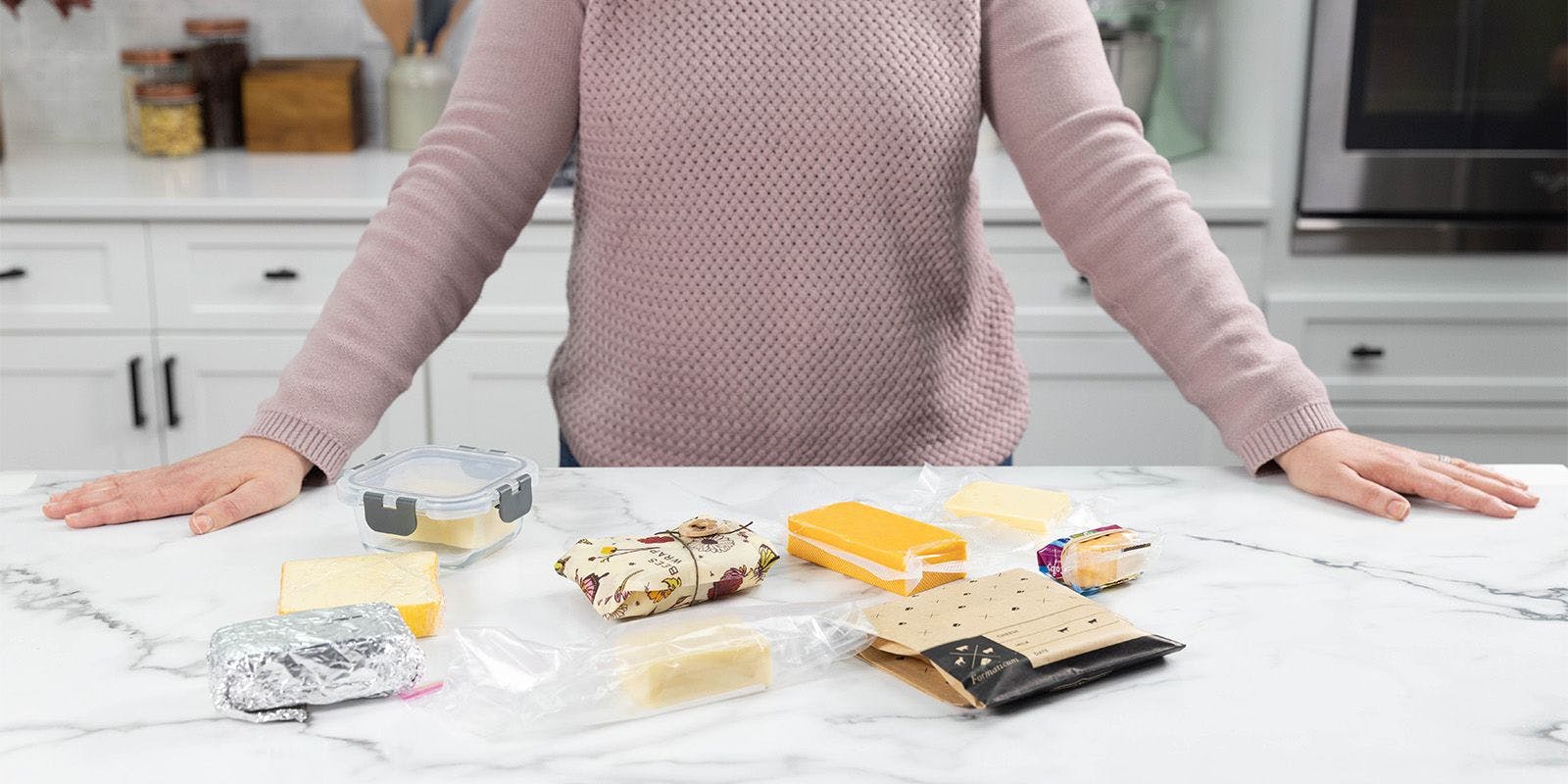 Examples of ways to store cheeses including wrapped in foil, plastic wrap and cheese paper.
